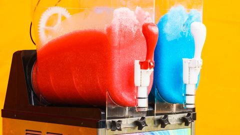 Two chamber slushie machine. One chamber contains red colored slushie; the other chamber contains blue colored slushie